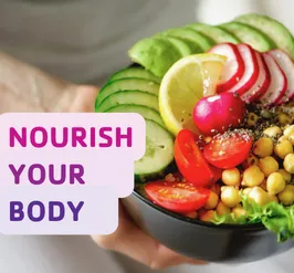 A close up shot of a colorful salad container heart healthy foods like avocado, chickpeas, and tomatoes. The text reads, "nourish your body."