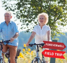 an older couple enjoying a bike ride. 