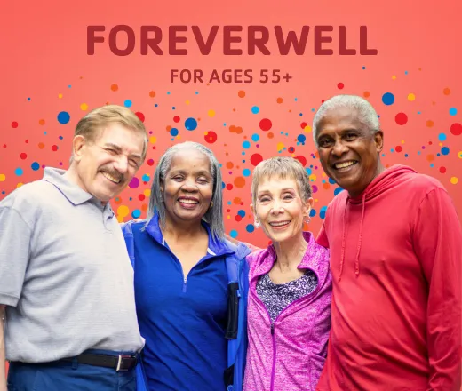 A group of older adults smiling underneath the ForeverWell logo
