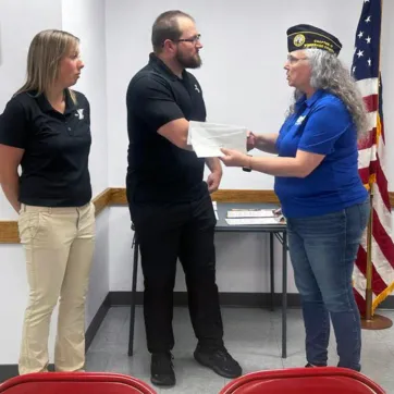 A representative of DAV shaking hands with a Y staff member. 