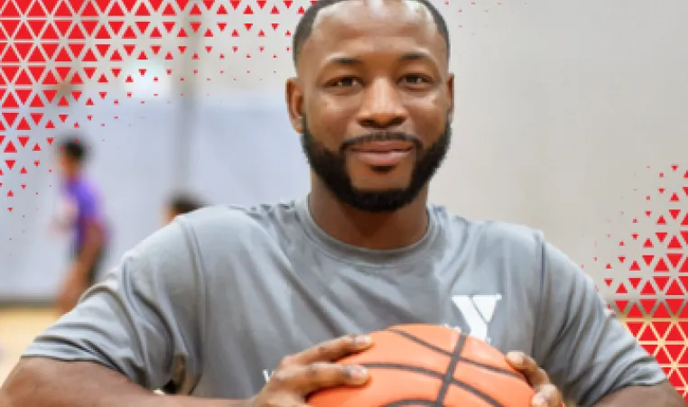 A man holding a basketball. 