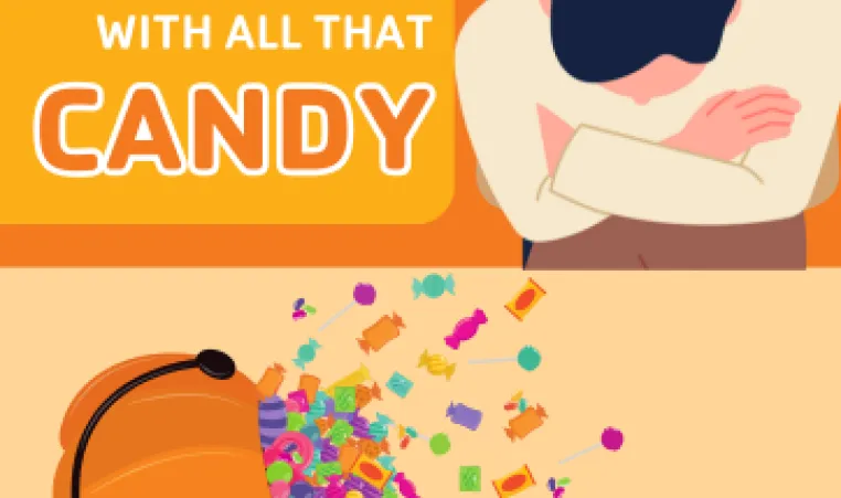 A dad looking at a pile of Halloween candy on the table.