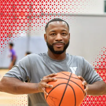 A man holding a basketball. 