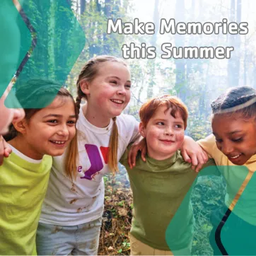 A group of YMCA campers in a group huddle before a fun outdoor camp activity.