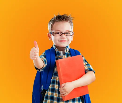 a school age child with a backpack giving a thumbs up.