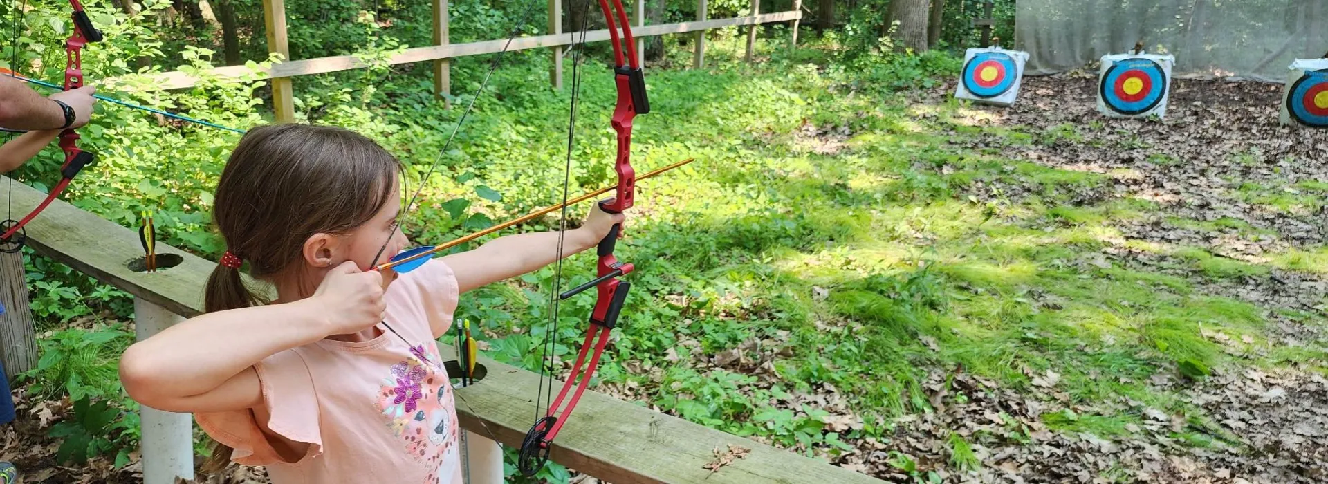Little girl doing archery