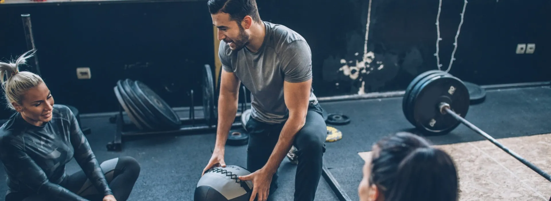Personal trainer working with 2 women