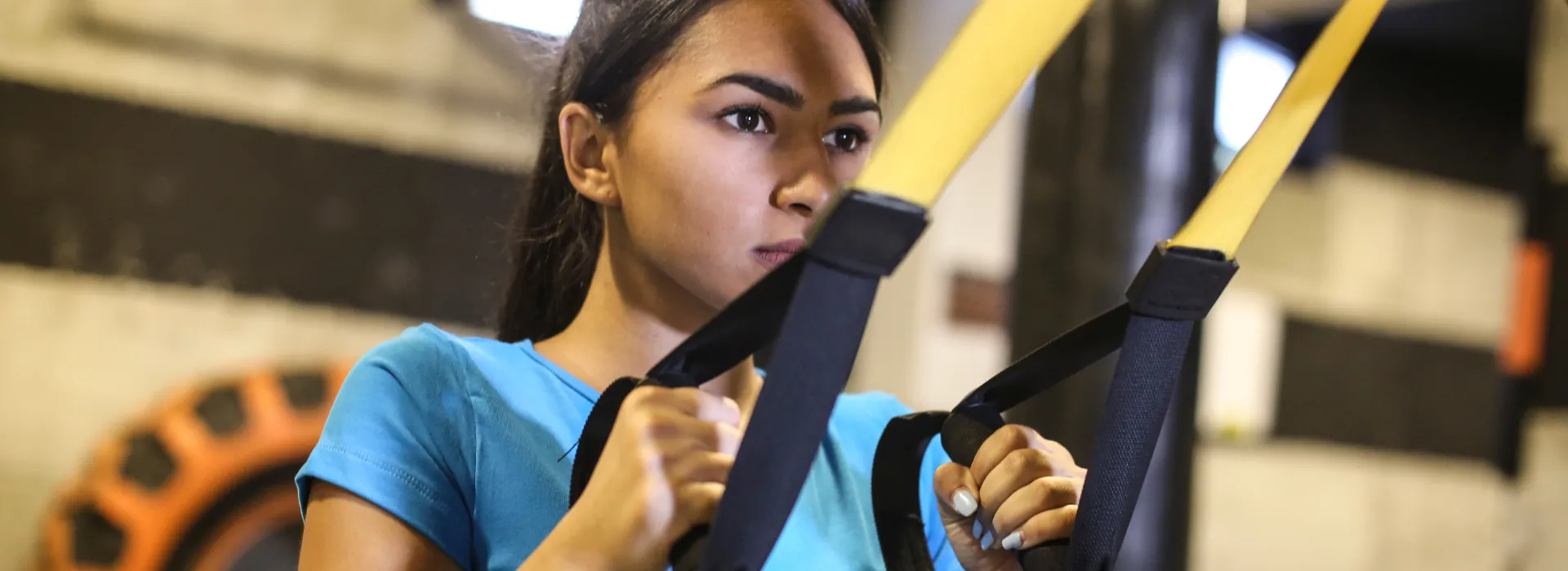 Teen girl using weight equipment