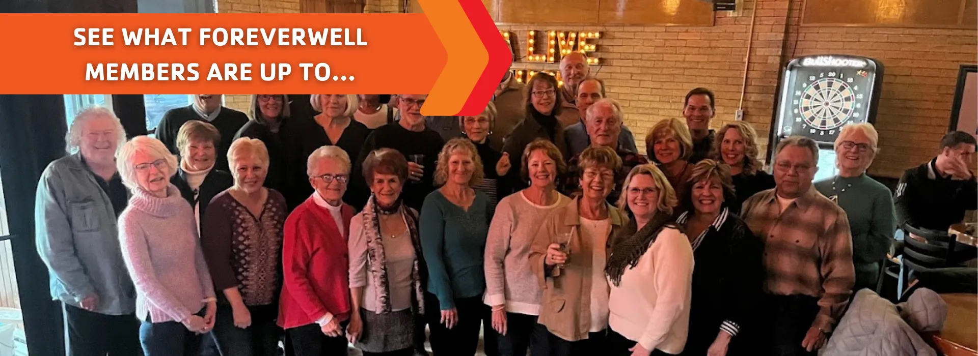 A large group of ForeverWell members at a live music event