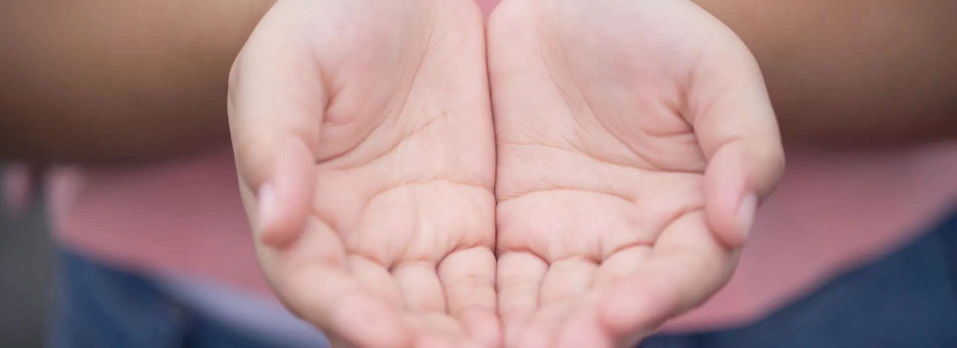 a person holding their hands out as if they are receiving a gift.